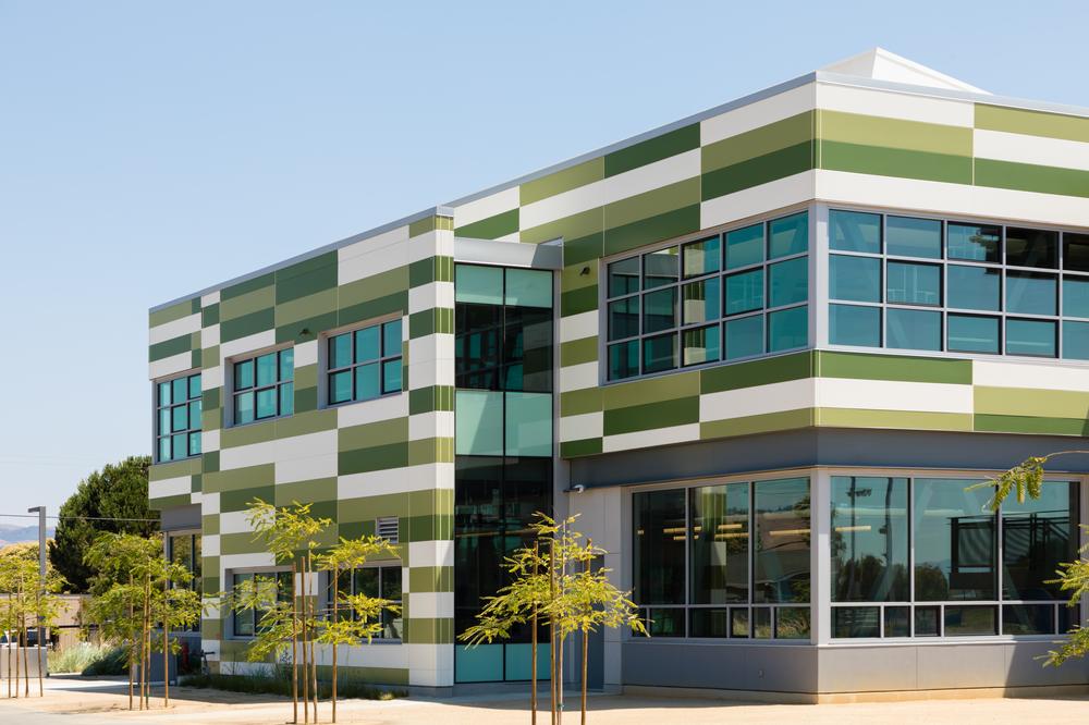 A close-up shot of Mount Eden High School utilizing Nichiha’s Illumination fiber cement cladding in custom shades of green and white.