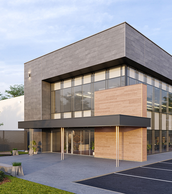 The exterior of a modern-style office building with gray fiber cement block panels surrounding tall windows and a wooden wall.