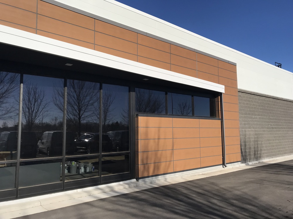 Nichiha’s RiftSawn fiber cement cladding in pecan on the walls of a Budget Blinds storefront.