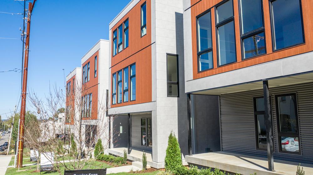 A close up of Nichiha&rsquo;s gray IndustrialBlock and VintageWood panels in the shade Redwood on a modern home development in Nashville, TN.