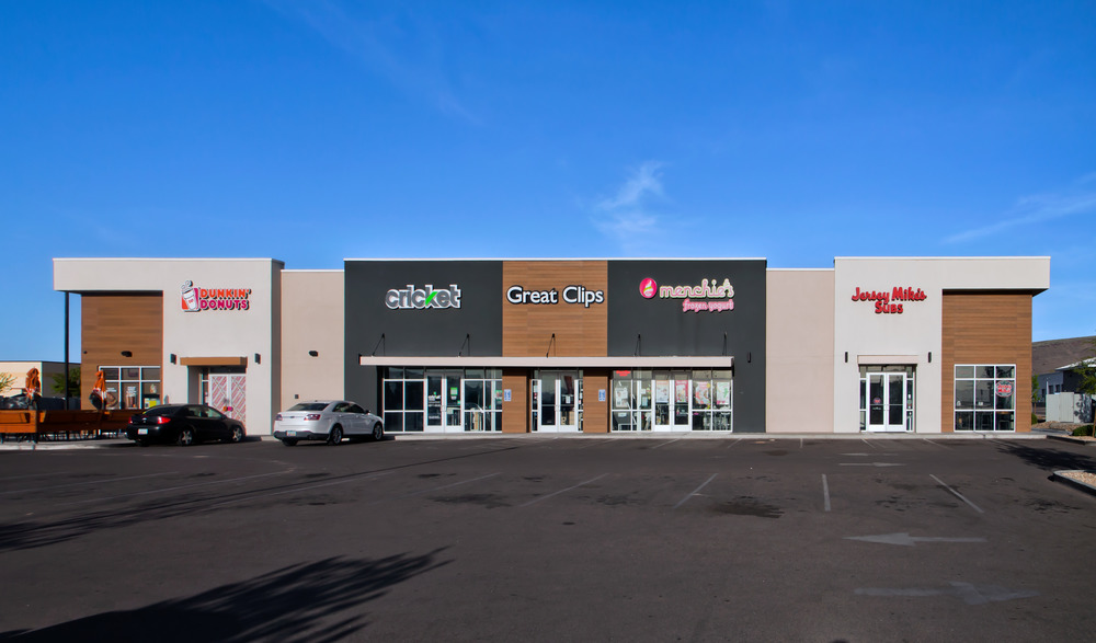 A retail strip mall housing Dunkin Donuts, Cricket, Great Clips, Menchie&rsquo;s and Jersey Mikes. The exterior walls are utilizing Nichiha&rsquo;s fiber cement cladding. Blue skies are behind it.