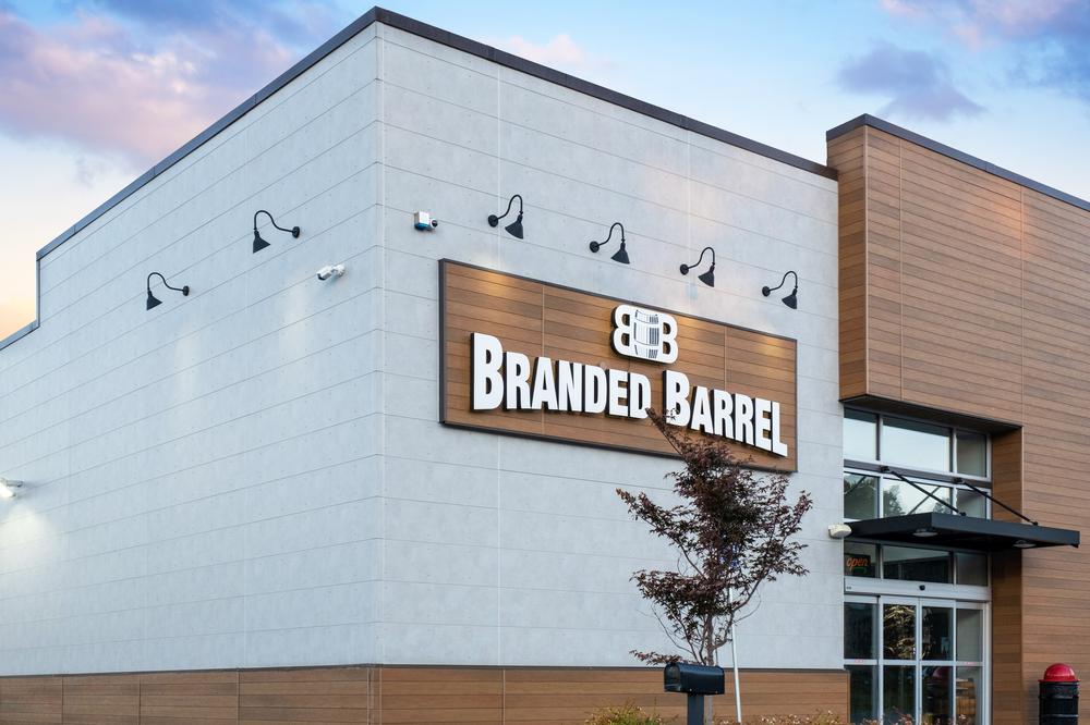 Storefront of Branded Barrel with gray and wood-look siding.