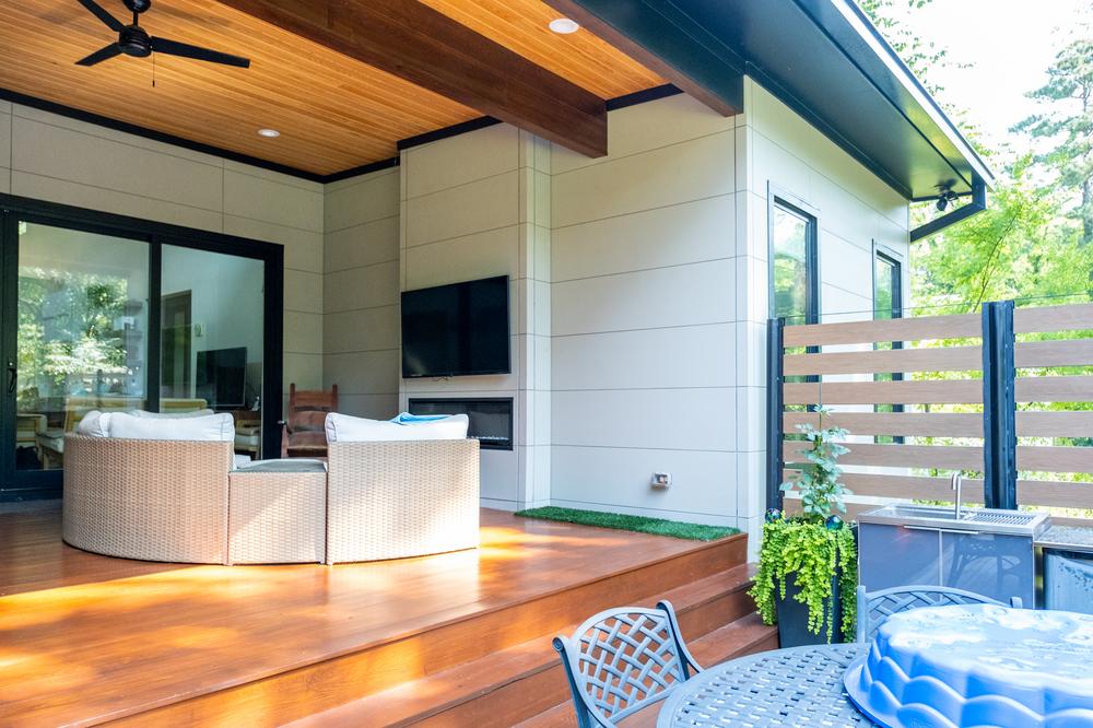 Nichiha’s fiber cement siding in white is being used on a back porch with an overhanging roof.