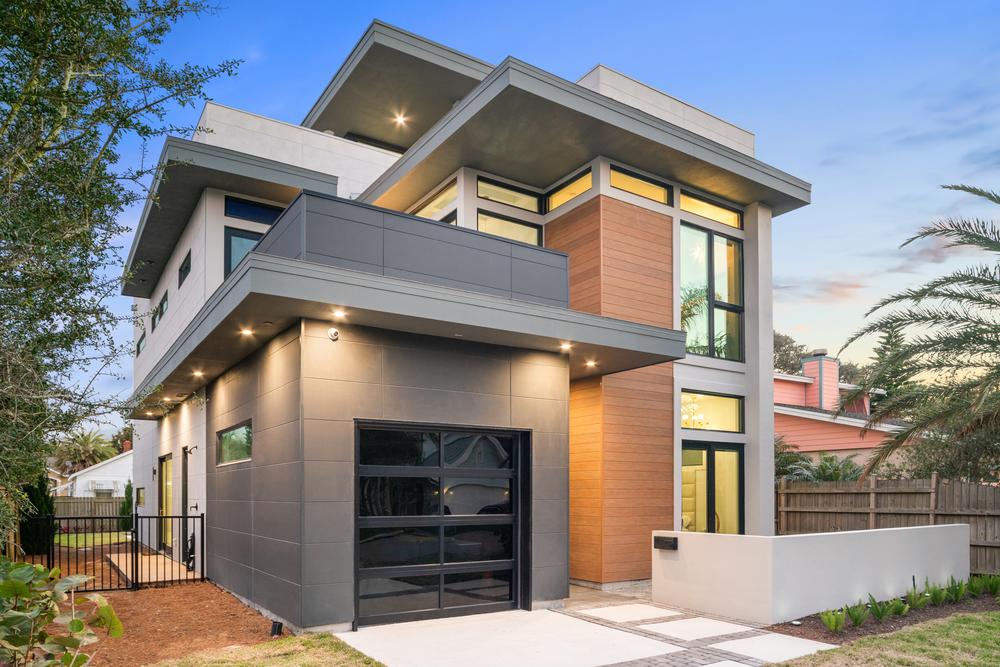 This modern home utilizes Nichiha’s VintageWood wood series. There is a concrete pad in front of the garage door.