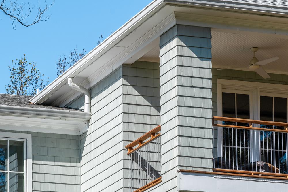 A photo of light gray Nichiha Sierra Shake Siding on the exterior of a traditional home.