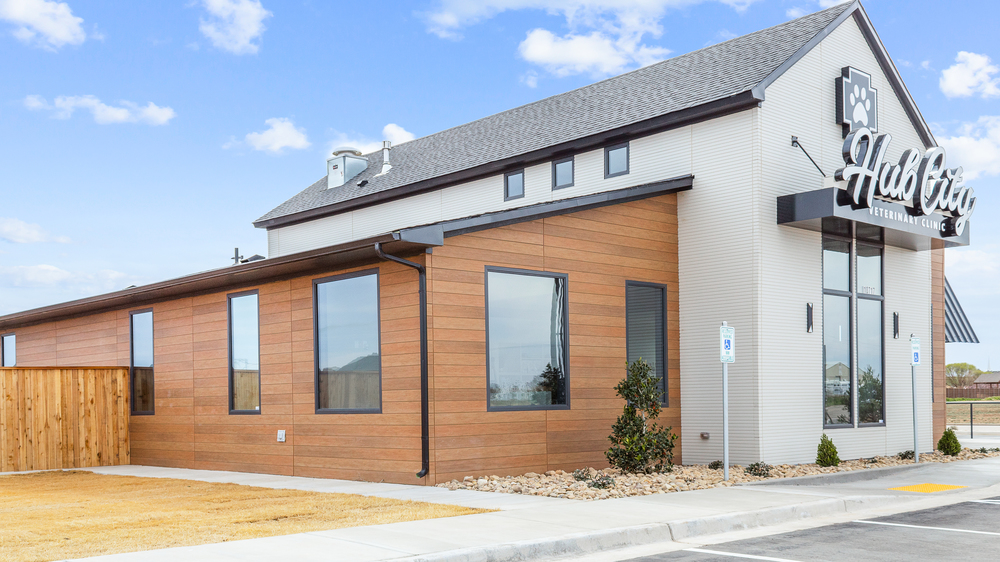 The exterior of Hub City Veterinary Clinic utilizing white and cedar Nichiha fiber cement cladding.