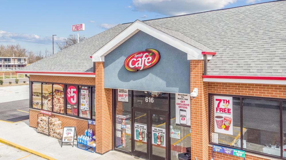 A close-up shot of Speedy Cafe convenience store with their red and white logo and Nichiha’s fiber cement cladding on the exterior that looks like brick.