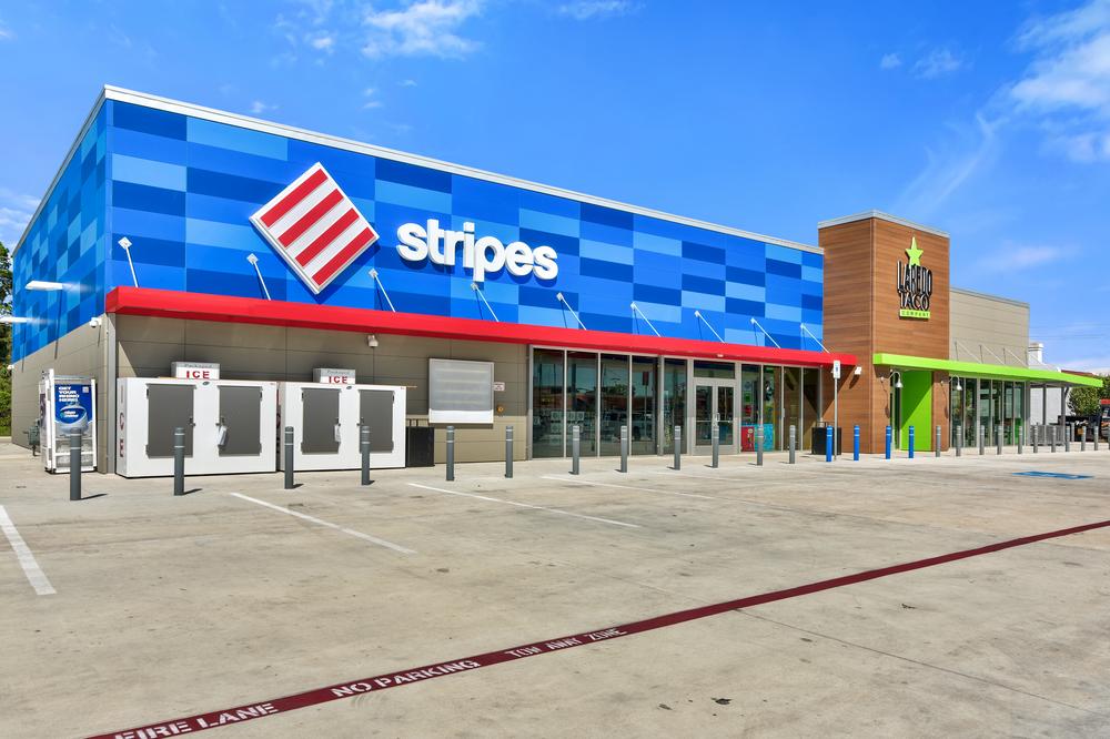 A Stripes convenience store with a white and red logo, blue fiber cement cladding from Nichiha in different shades, and Nichiha’s VintageWood cladding series.