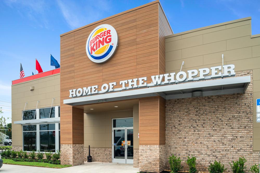 A Burger King restaurant has fiber cement siding. There is a “Home Of The Whopper” sign above the entrance.