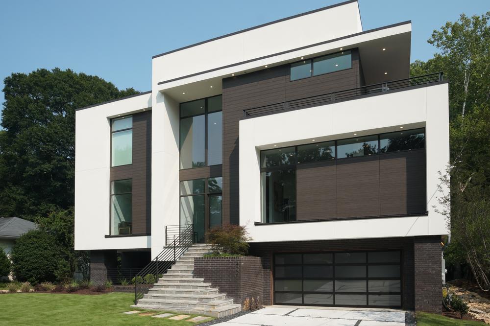 A white and dark brown home with geometric shapes decorated with Nichiha’s fiber cement siding.