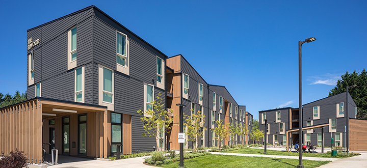 Elwood multifamily building with gray and wood siding