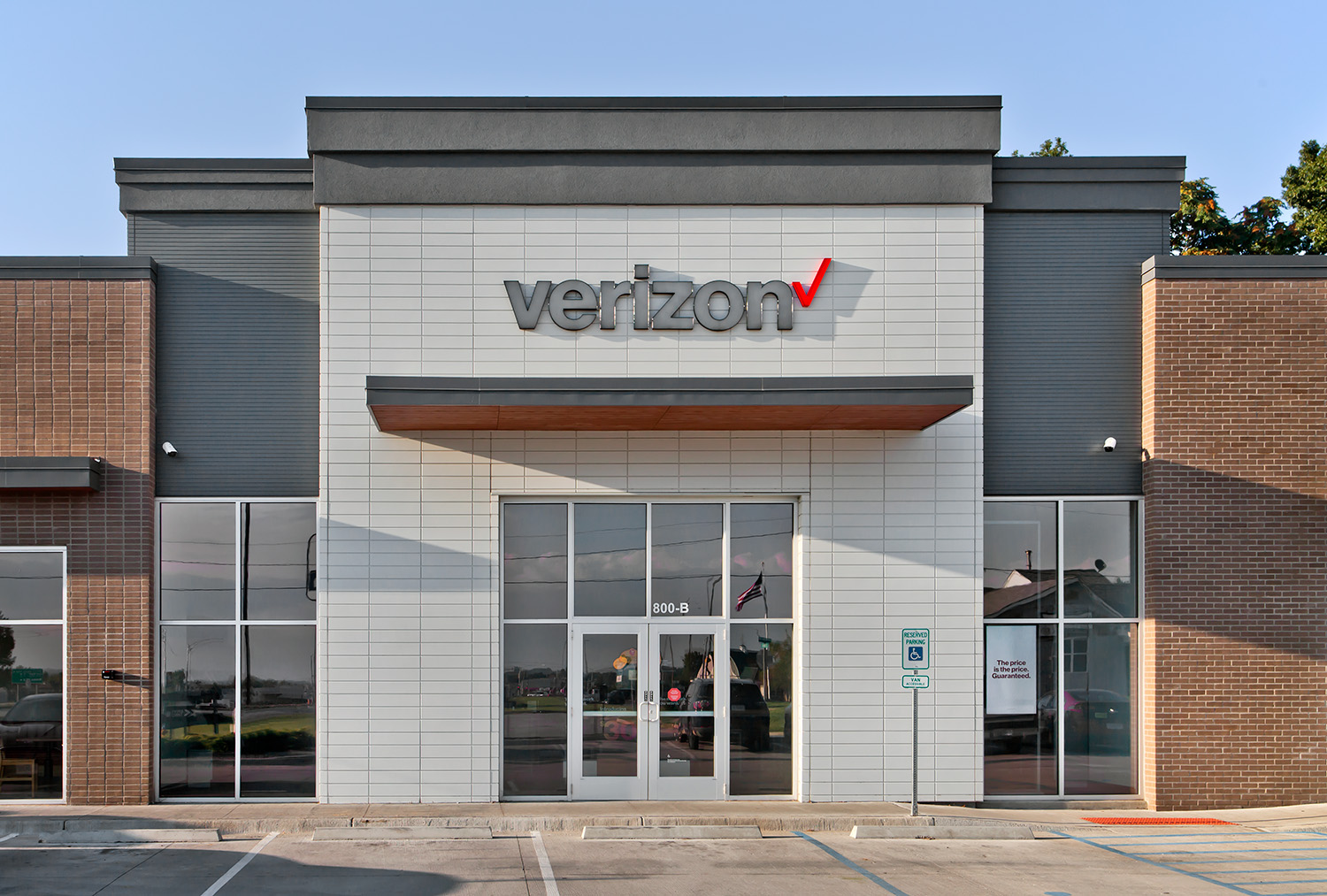 Front entrance of a Verizon retail space with Novenary architectural wall panels in Opal