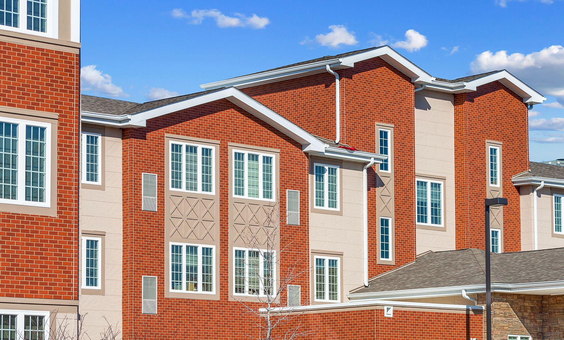 Multifamily exterior with PlymouthBrick and Sandstone