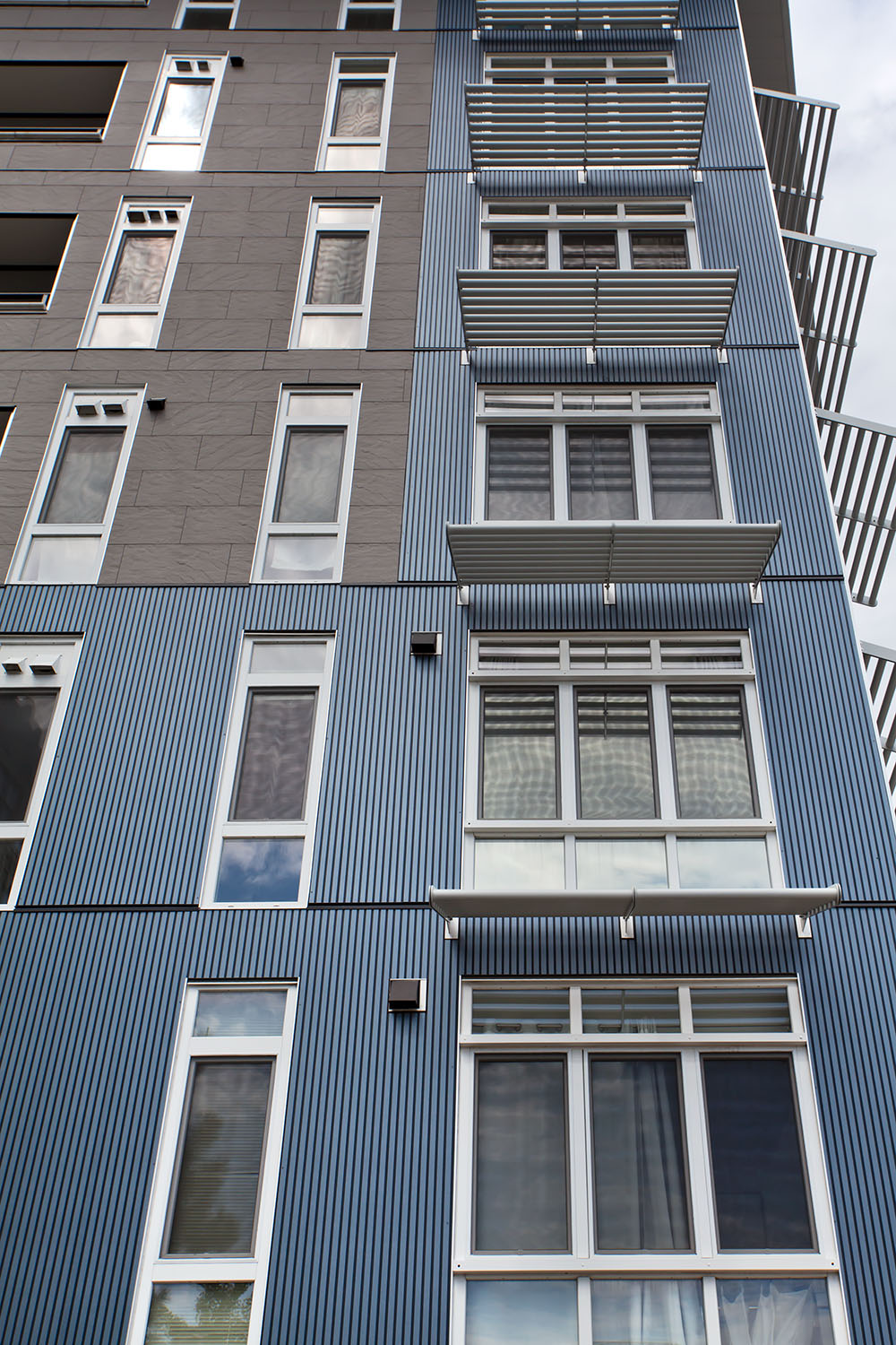 View of Point 262 looking up from the street to see Ribbed panels from Nichiha installed vertically
