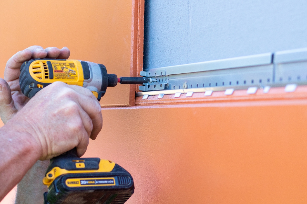 dewalt 20v drill installing an AWP rainscreen wall panel
