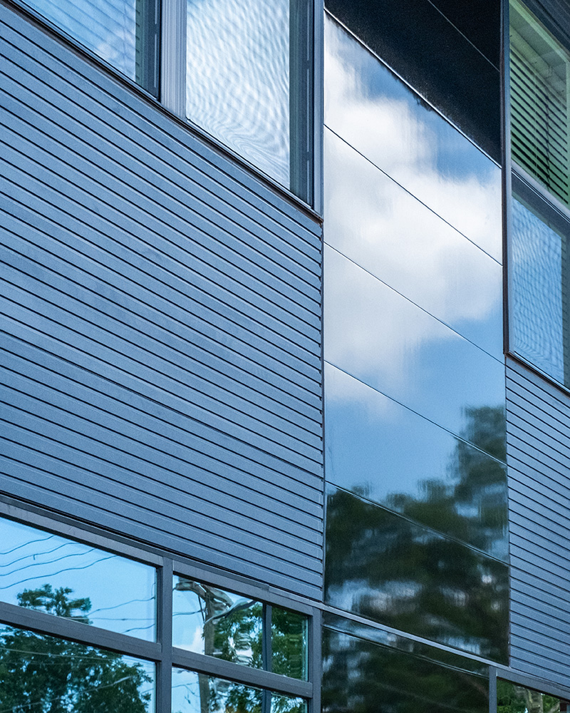 Close up detail of Ribbed and Miraia panels on Riverside multifamily building